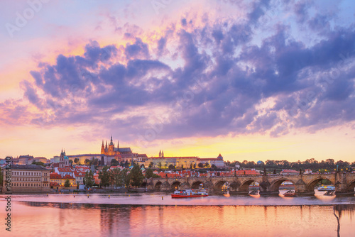 City summer landscape at sunset - view of the Charles Bridge and castle complex Prague Castle in the historical center of Prague, Czech Republic