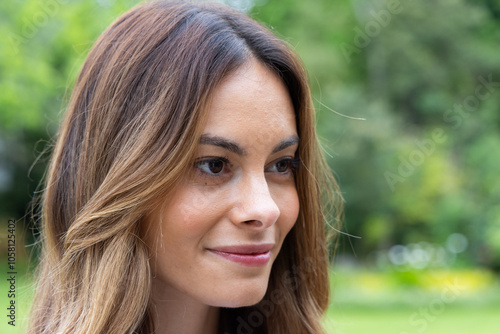 Smiling woman enjoying peaceful moment outdoors in lush green garden