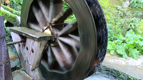 Wooden water mill. Breastshot water wheel system photo