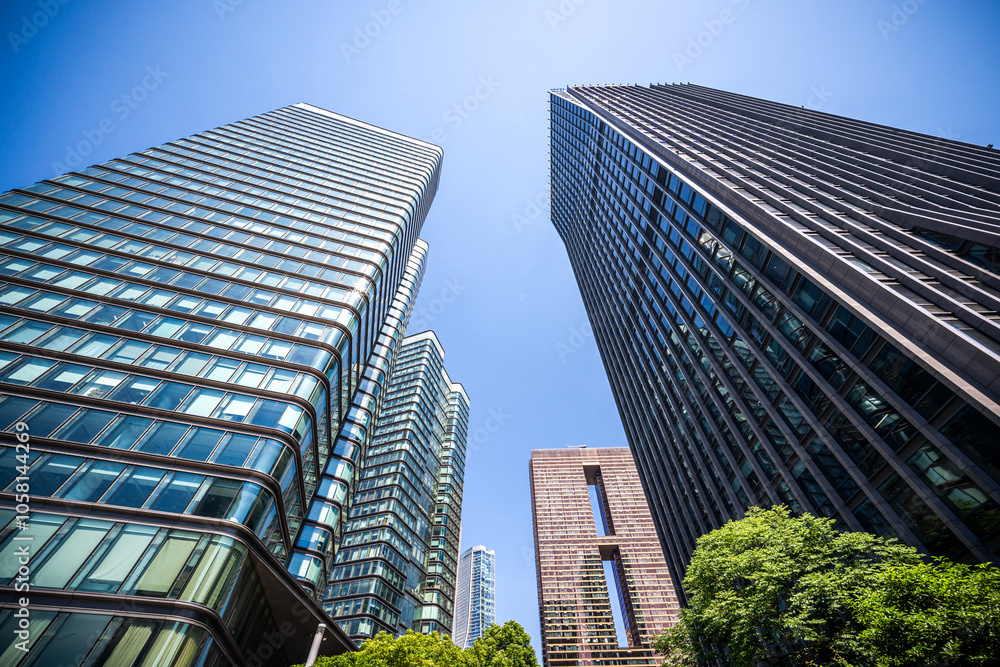 Modern Urban Architecture: Tall Skyscrapers Soaring Under Clear Blue Sky Modern Urban Architecture: Tall Skyscrapers Soaring Under Clear Blue Sky