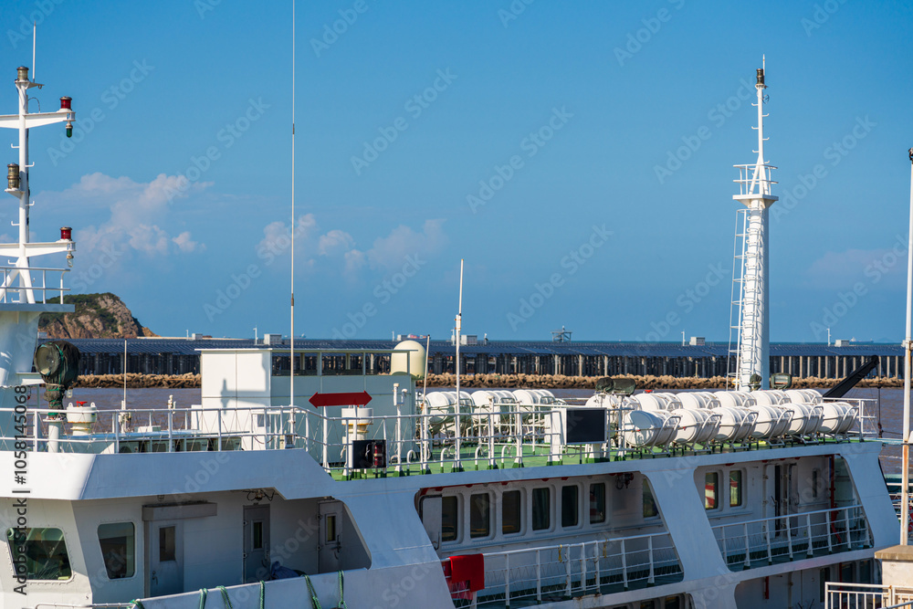 Modern Ferryboat at Port with Scenic Background and Clear Sky