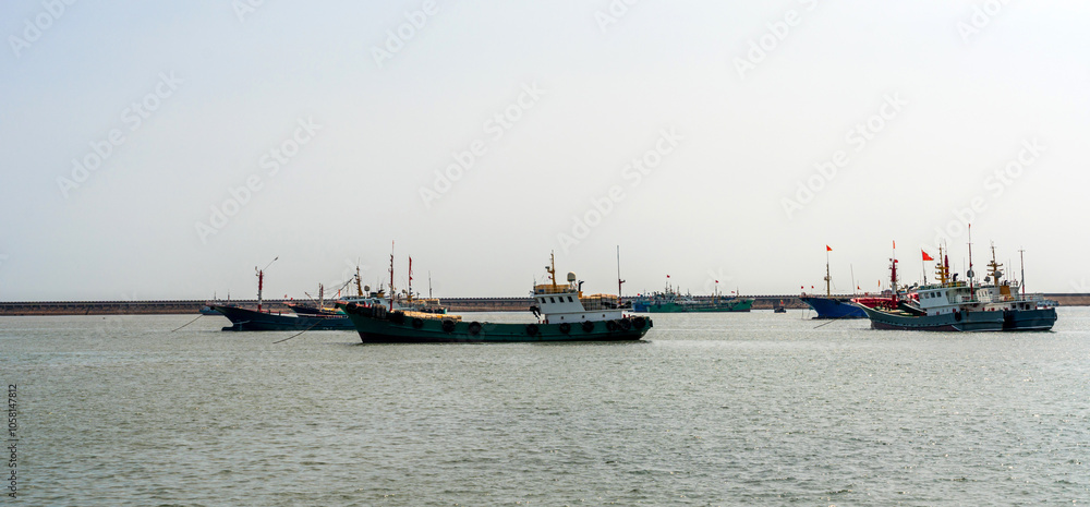 Serene Harbor Scene with Multiple Fishing Vessels on Calm Waters Serene Harbor Scene with Multiple Fishing Vessels on Calm Waters