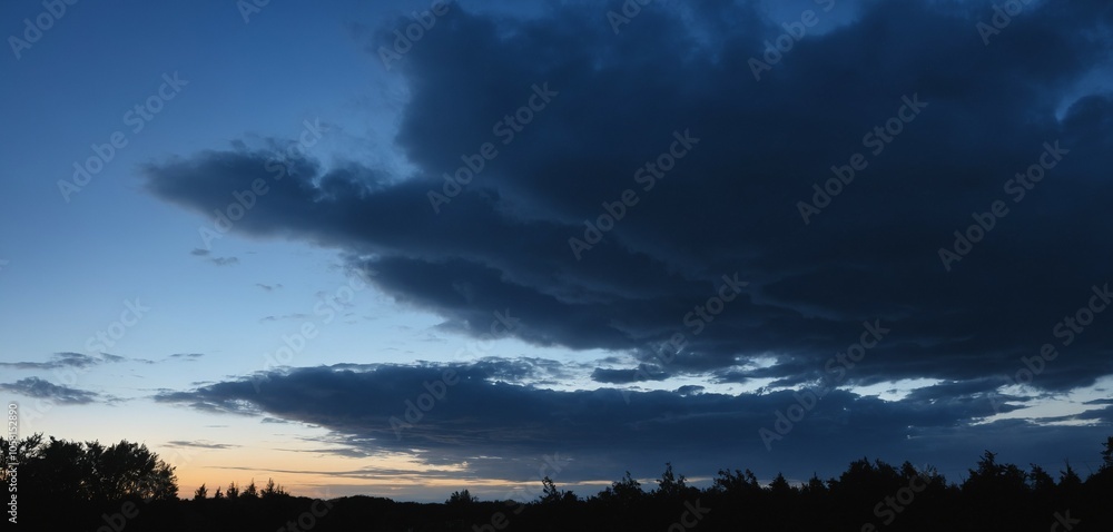 Deep blue evening sky with dark, shadowed clouds and hints of fading light for a calming twilight scene Deep blue evening sky with dark, shadowed clouds and hints of fading light for a calming twilight scene