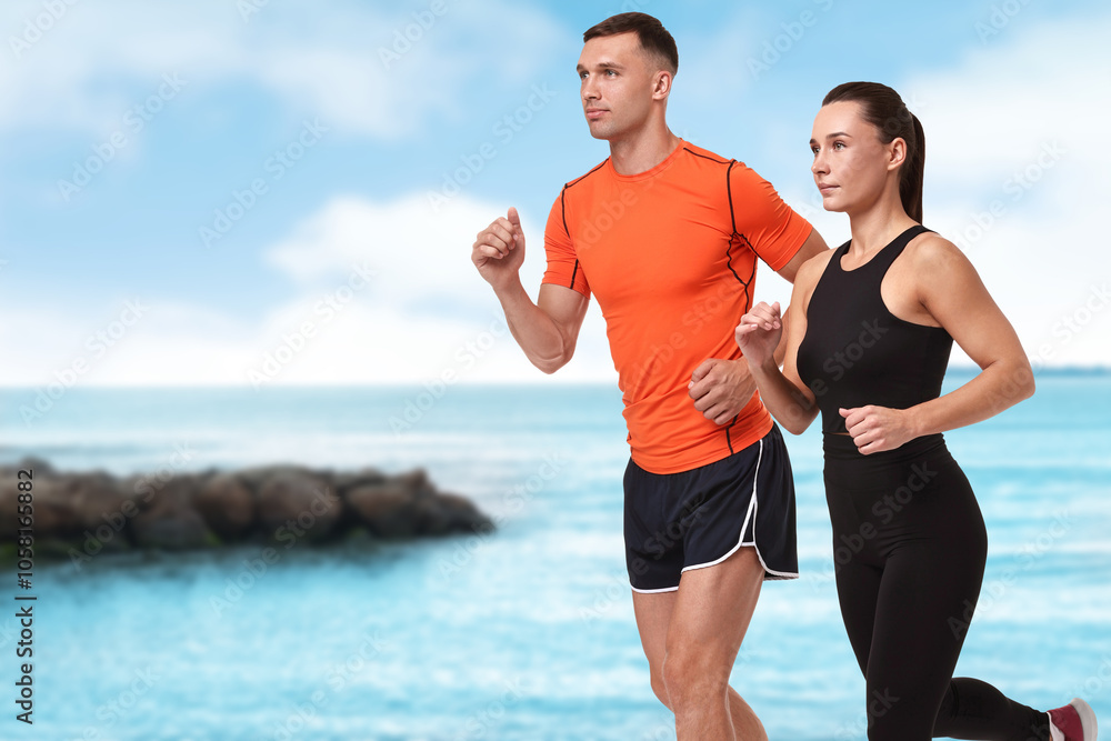 Couple in sportive clothes running on beach. Space for text Couple in sportive clothes running on beach. Space for text