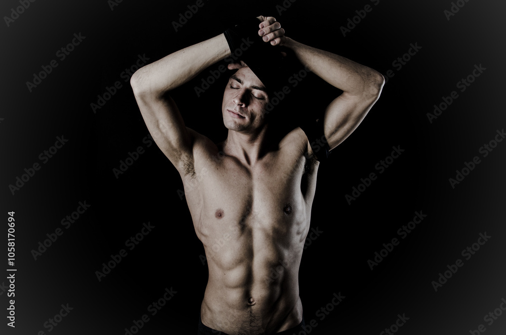 Young attractive man with athletic body posing in studio. Young attractive man with athletic body posing in studio.