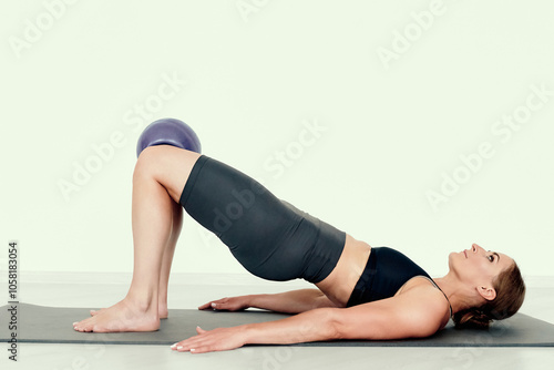 Fitness Instructor Demonstrating Glute Bridge with Ball