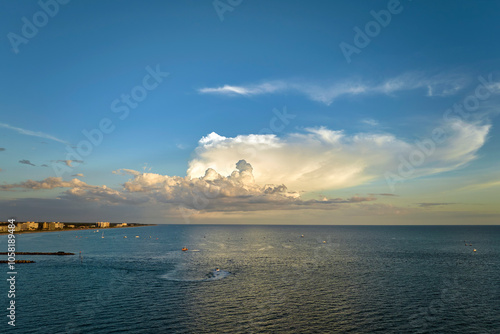 Aerial view of sea shore near Venice, Florida with white yachts at sunset floating on sea waves. North and South Jetty on Nokomis beach. Motor boat recreation on ocean surface photo