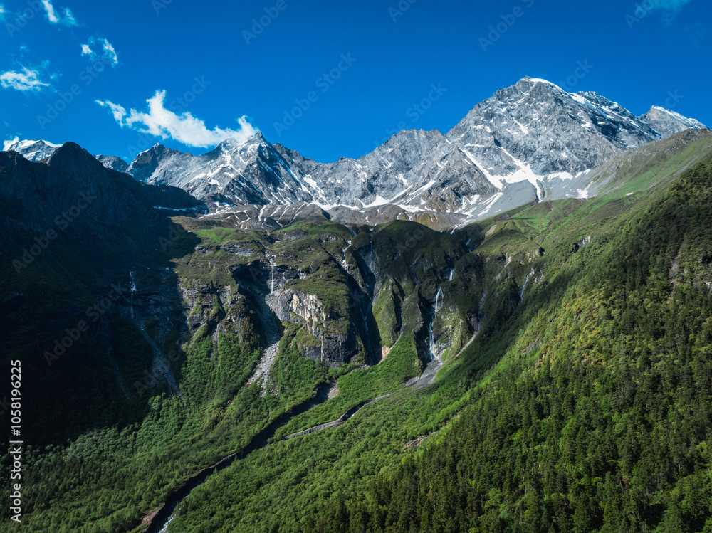 Fototapeta premium Aerial view of beautiful high altitude snow capped mountain and waterfall landscape
