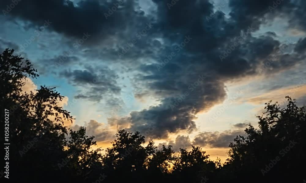 A serene sky filled with clouds at sunset, framed by silhouettes of trees below. A serene sky filled with clouds at sunset, framed by silhouettes of trees below.