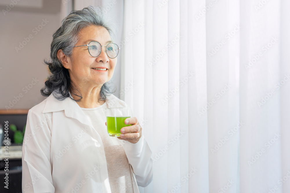healthy asian senior woman relaxing by the window holding natural fruit juice,smiling with wellness,elderly lifestyle,health care healthy asian senior woman relaxing by the window holding natural fruit juice,smiling with wellness,elderly lifestyle,health care