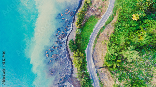 Aerial view of curve road along the seashore with beautiful seacoast open sea in summer