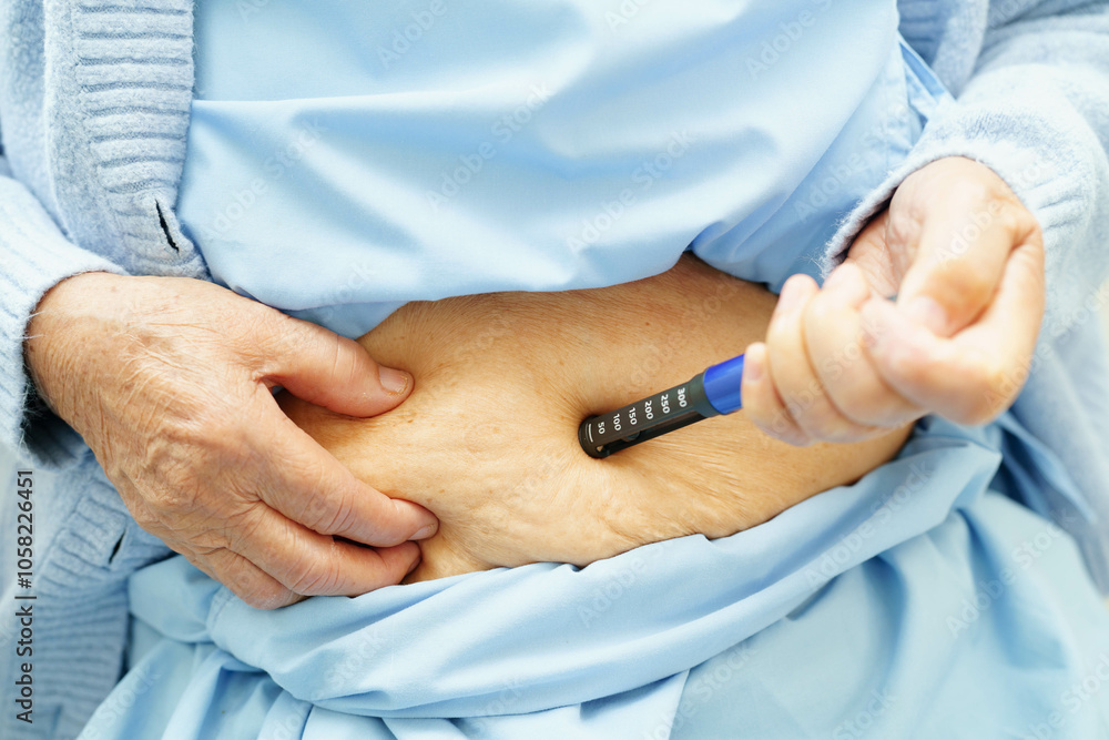 Asian senior woman making injection insulin pen in belly to treatment diabetes. Asian senior woman making injection insulin pen in belly to treatment diabetes.