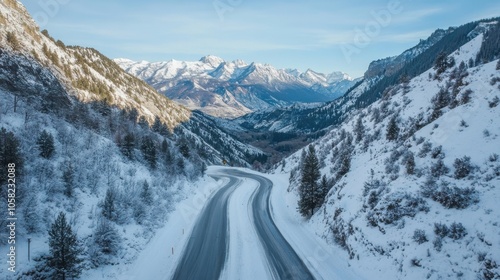 A picturesque snowy road cutting through a mountain pass,