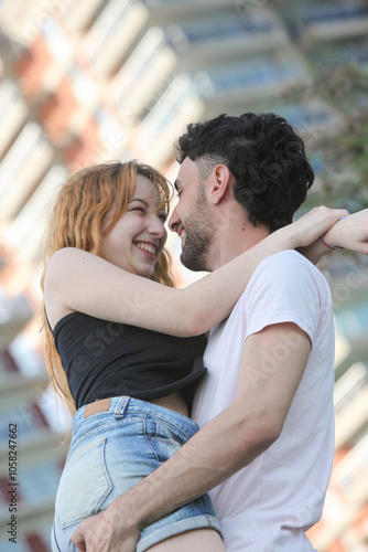 candid portrait of cute cheerful young couple at the park 