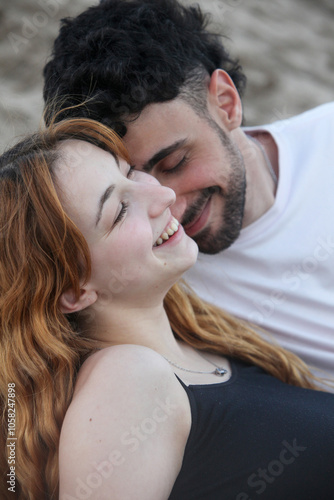 closeup portrait of cute loving young couple on the beach