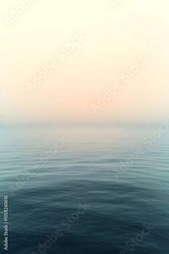 A serene view of a calm ocean at dawn, showcasing gentle waves and soft pastel colors blending in the sky, evoking a tranquil and peaceful atmosphere.