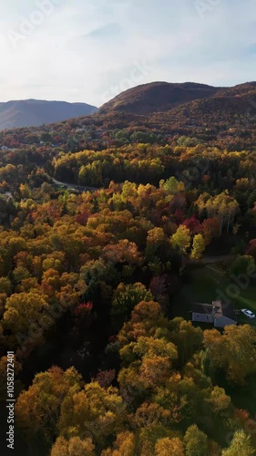 Cape Smokey Mountains along Ingonish Beach, Cabot Trail, Cape Breton, Nova Scotia, Canada. Incredible blue ocean waters with  the autumn fall foliage colors.  [Vertical Video]