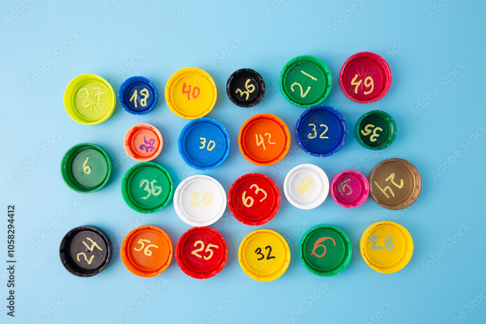 Multiplication problems on colorful bottle caps arranged on blue background, educational flat lay for kids math practice, multiplication table learning, math activity, home math learning aid, Multiplication problems on colorful bottle caps arranged on blue background, educational flat lay for kids math practice, multiplication table learning, math activity, home math learning aid,