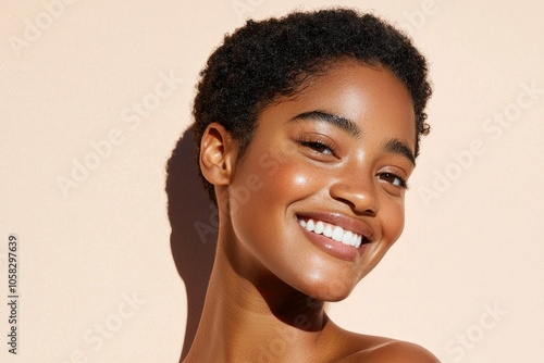Joyful expression of confidence a smiling black woman with short hair on a clean background