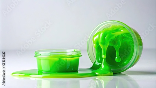 Thick, sticky slime drips from a small container on a pristine white background, surrounded by nothing but empty space, gooey, liquid, isolated, texture