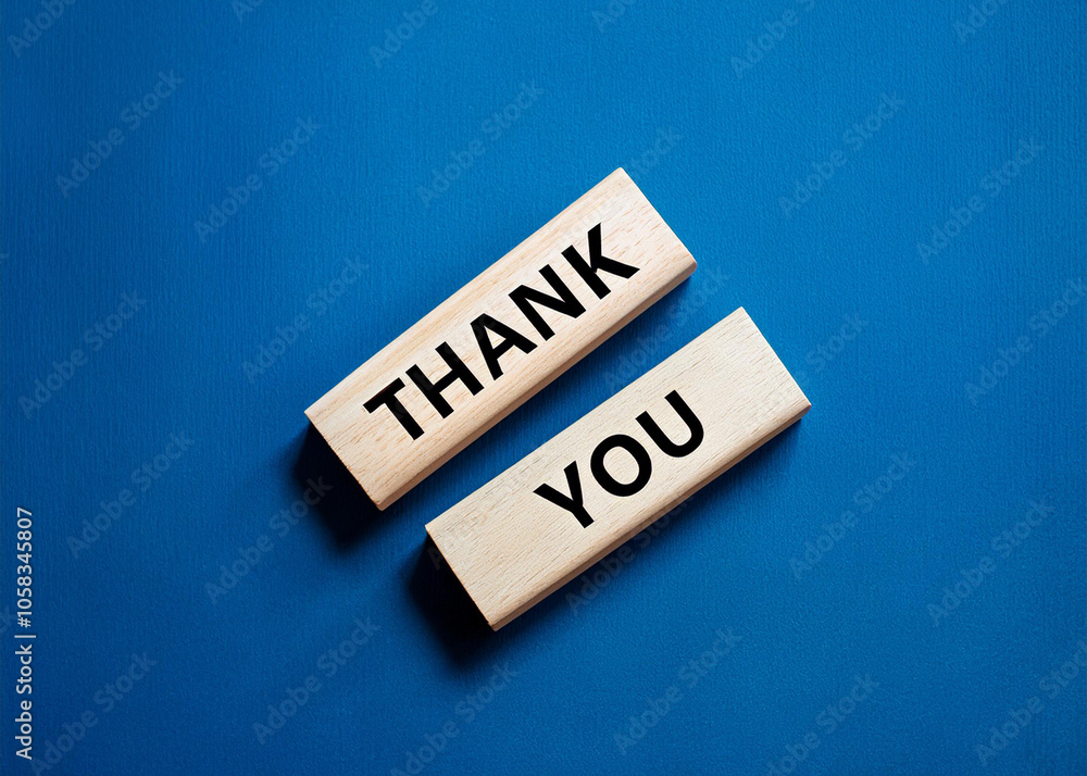 Thank you symbol. Wooden blocks with words Thank you. Beautiful blue background. Thank you symbol. Wooden blocks with words Thank you. Beautiful blue background.
