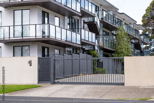 Εκτύπωση καμβά Modern apartment complex featuring multiple balconies with glass railings and a metal gated entrance
