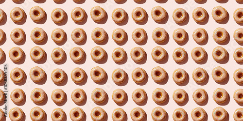 A seamless pattern of donuts, each with its shadow, scattered across the canvas in an elegant display, with soft shadows on a soft pale pink color background