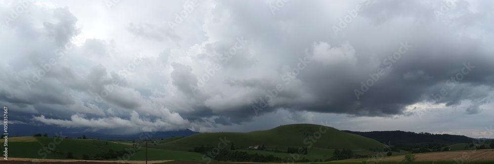 Dramatic stormy sky over lush green hills, rural, clouds, scenery Dramatic stormy sky over lush green hills, rural, clouds, scenery