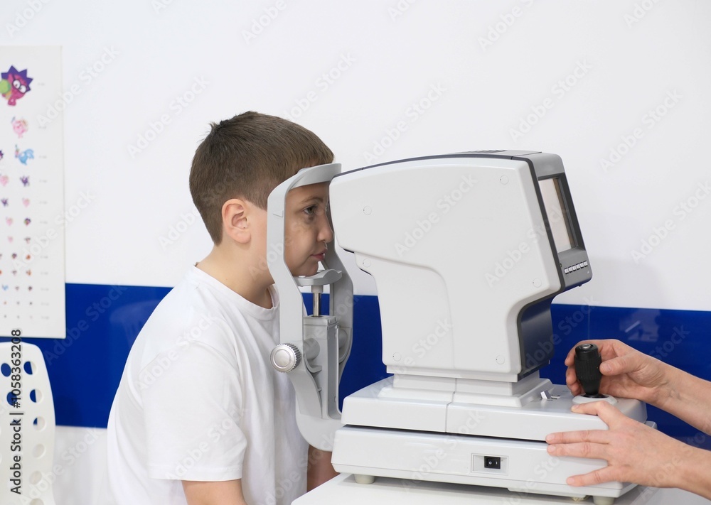 Little boy undergoing eye test in clinic. Little boy undergoing eye test in clinic.