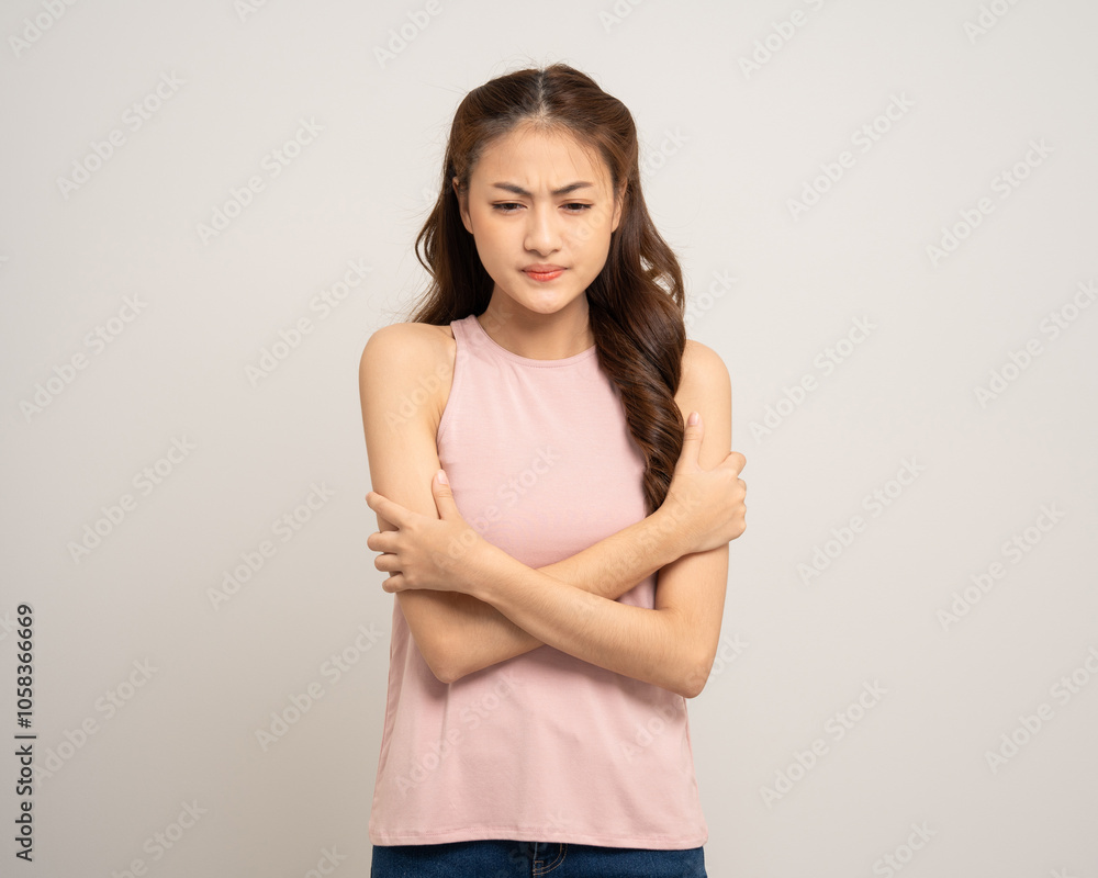 Young asian woman feel cold. Frozen Winter season. Hug herself warming up temperature. Female trembles Feel bad and suffer. Unwell woman on isolated background Young asian woman feel cold. Frozen Winter season. Hug herself warming up temperature. Female trembles Feel bad and suffer. Unwell woman on isolated background