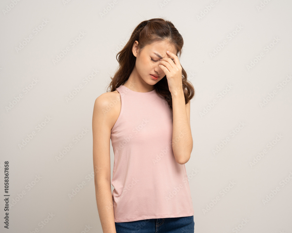 Young asian unwell unhealthy woman hand touching head she's feeling depressed stress headache be tired from working standing on isolated white background she has symptom office syndrome. Young asian unwell unhealthy woman hand touching head she's feeling depressed stress headache be tired from working standing on isolated white background she has symptom office syndrome.