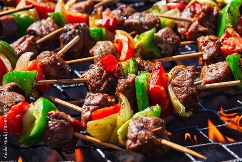 barbeque skewers with meat green peppers , red, and onions,