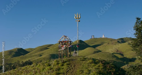 sacred Drone view of Lord Shiva's Trishul Trident Dolakha Sailung, Nepal green hill landscape with mountains and blue skies near Tibet, spiritual site ideal for peaceful camping and divine connection photo