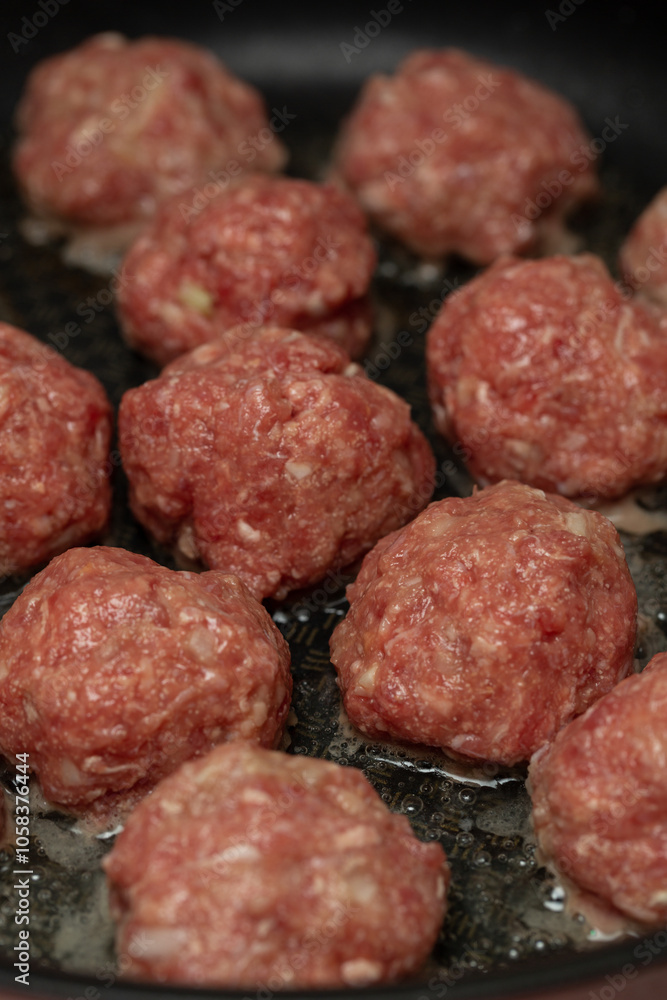 Meat balls are fried in a frying pan in vegetable oil Meat balls are fried in a frying pan in vegetable oil