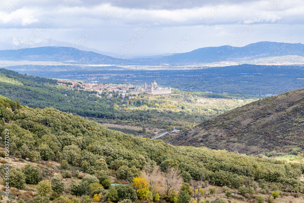 Obraz premium Royal Monastery of San Lorenzo de El Escorial, seen through the fog, from the Cruz Verde mountain pass
