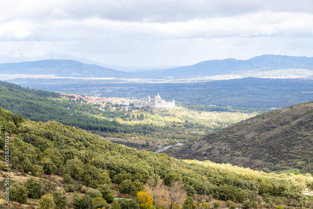 Royal Monastery of San Lorenzo de El Escorial, seen through the fog, from the Cruz Verde mountain pass Royal Monastery of San Lorenzo de El Escorial, seen through the fog, from the Cruz Verde mountain pass