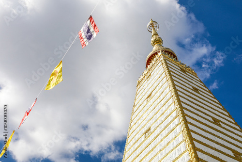 Wat Phra That Nong Bua, Ubon Ratchathani, inside there is the Phra That Sri Maha Bodhi Chedi, a replica of the Chedi in Bodh Gaya, India, stucco sculptures, candles, and two large Naga statues. photo