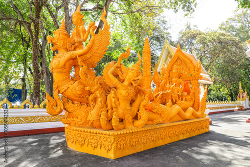 Wat Phra That Nong Bua, Ubon Ratchathani, inside there is the Phra That Sri Maha Bodhi Chedi, a replica of the Chedi in Bodh Gaya, India, stucco sculptures, candles, and two large Naga statues. photo