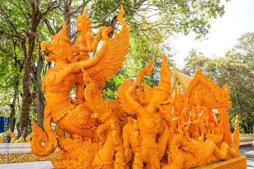 Wat Phra That Nong Bua, Ubon Ratchathani, inside there is the Phra That Sri Maha Bodhi Chedi, a replica of the Chedi in Bodh Gaya, India, stucco sculptures, candles, and two large Naga statues. photo