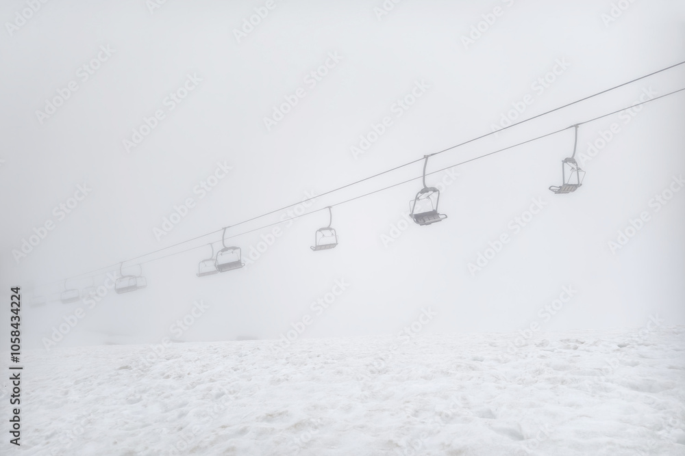 ski resort, cable car funicular in thick white fog. ski resort, cable car funicular in thick white fog.