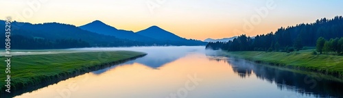 Flowing river reflecting early morning fog in a quiet valley, surrounded by mountainous terrain and softened by the peaceful glow of dawn photo