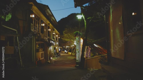 Empty And Quiet Street At Night Along The Buildings In Japan. - wide shot photo