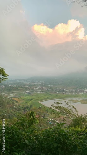 View of Buyan Lake, Pancasari Village and Pura ulun danu bayun in Buleleng, Bali. Large caldera with green water surrounded by mountains, Vertical video photo