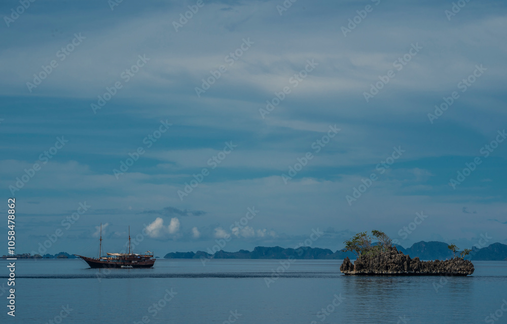 liveaboard anchored in calm waters at Raja Ampat liveaboard anchored in calm waters at Raja Ampat