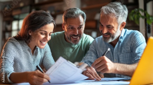 Three men are sitting at a table with a piece of paper in front of them. One of the men is writing on the paper while the other two men look on. Scene is one of collaboration and teamwork