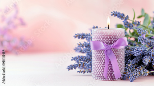 Lavender candle decorative scented candle with a purple ribbon and lavender flowers on pink background photo