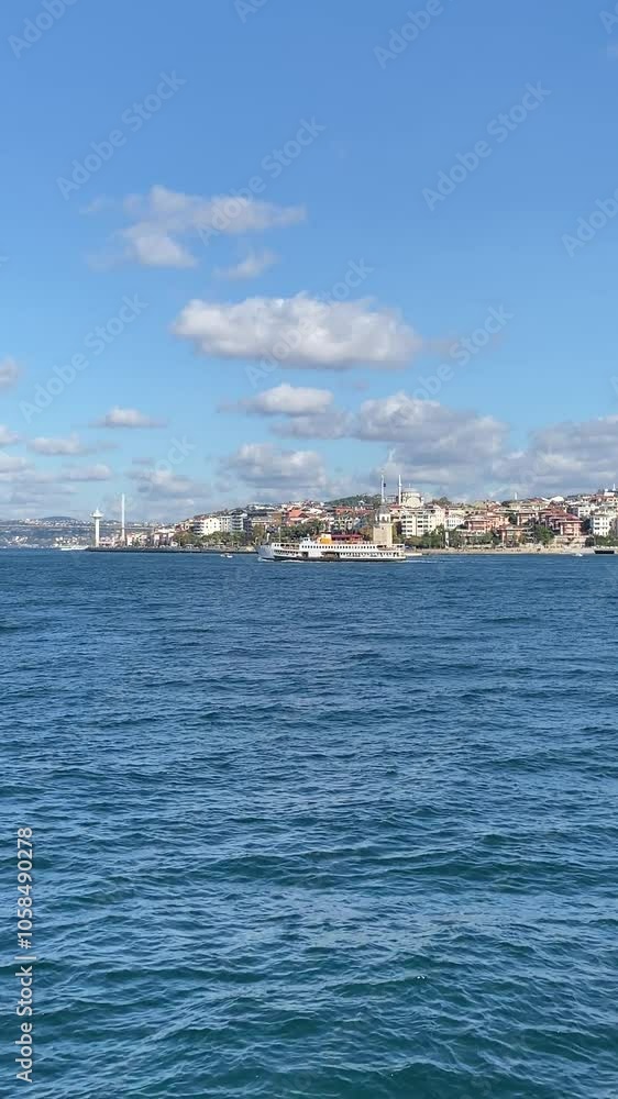 Istanbul, Turkey, 24 October 2024: View of a traditional Turkish ferry sailing on the Bosphorus with the Kiz Tower and Istanbul's coastline in the background. Istanbul, Turkey, 24 October 2024: View of a traditional Turkish ferry sailing on the Bosphorus with the Kiz Tower and Istanbul's coastline in the background.