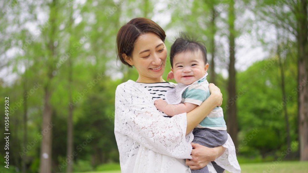 生後6ヶ月の赤ちゃんを抱っこする30代女性 生後6ヶ月の赤ちゃんを抱っこする30代女性