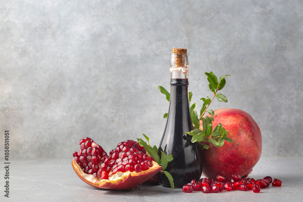 Organic homemade pomegranate syrup, pomegranate juice or pomegranate sauce with fresh pomegranate fruits. Turkish name; nar eksisi - nar suyu