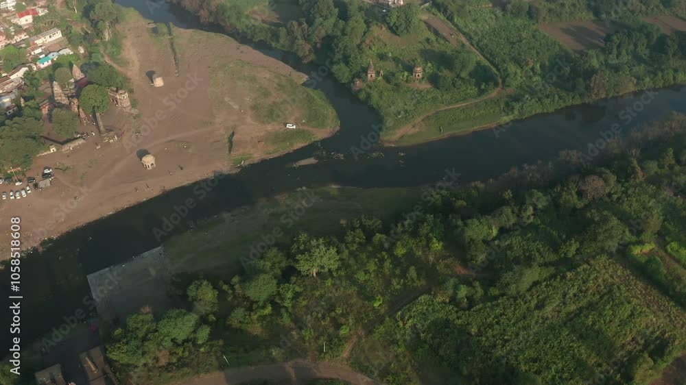 Scenic confluence of Krishna and Venna rivers, merging waters flowing amidst lush greenery and serene landscapes Scenic confluence of Krishna and Venna rivers, merging waters flowing amidst lush greenery and serene landscapes